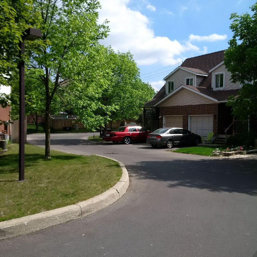 A street with cars parked on the side of it.