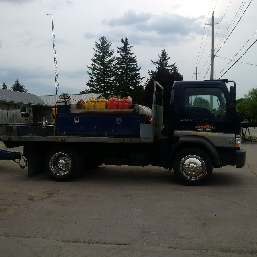 A truck with a trailer full of fruit on the back.