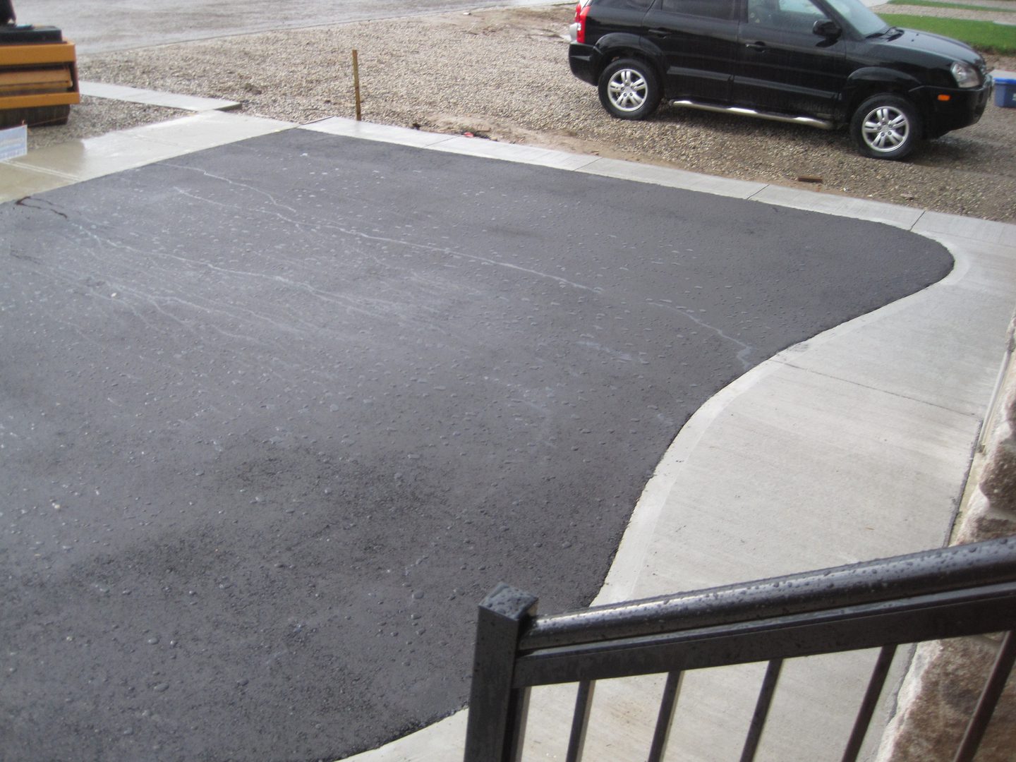 A car parked in the driveway of a home.