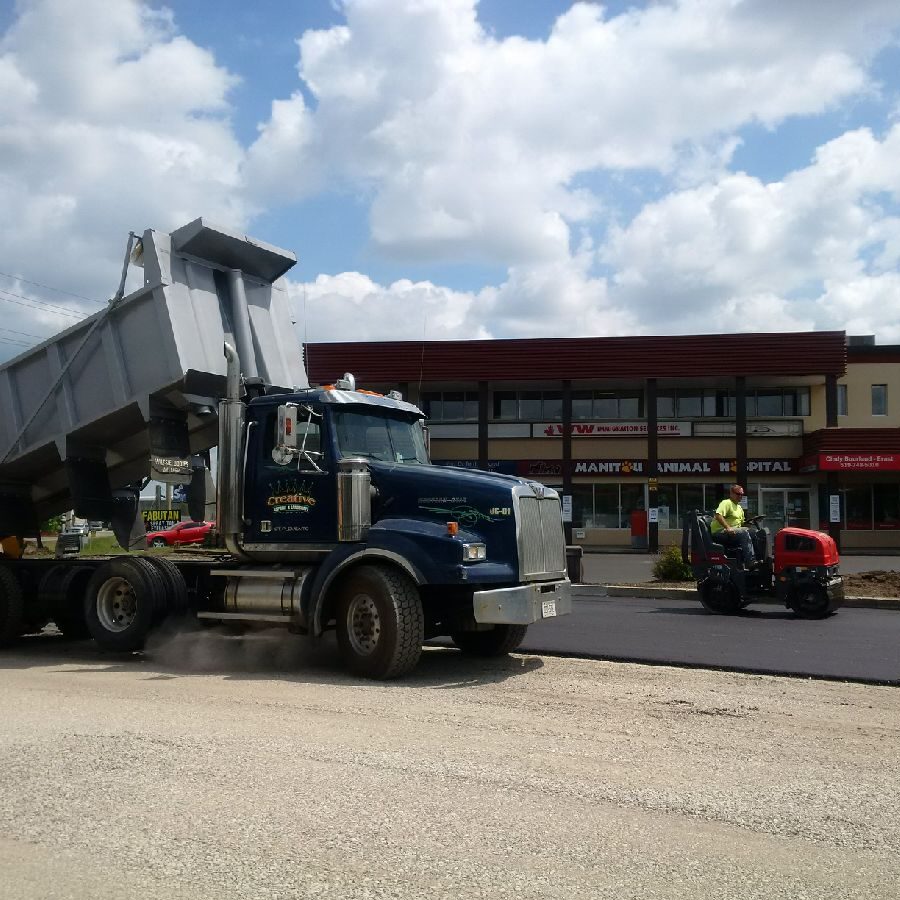 A dump truck is parked on the side of the road.