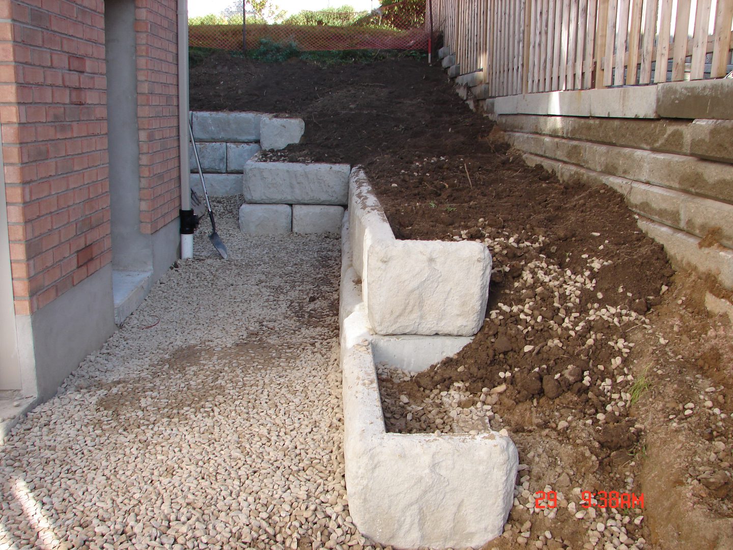 A garden bed with concrete blocks and dirt.