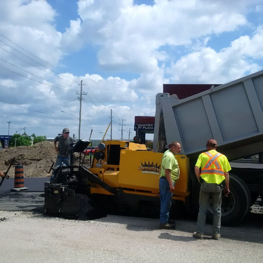 A dump truck is being loaded with rubble.