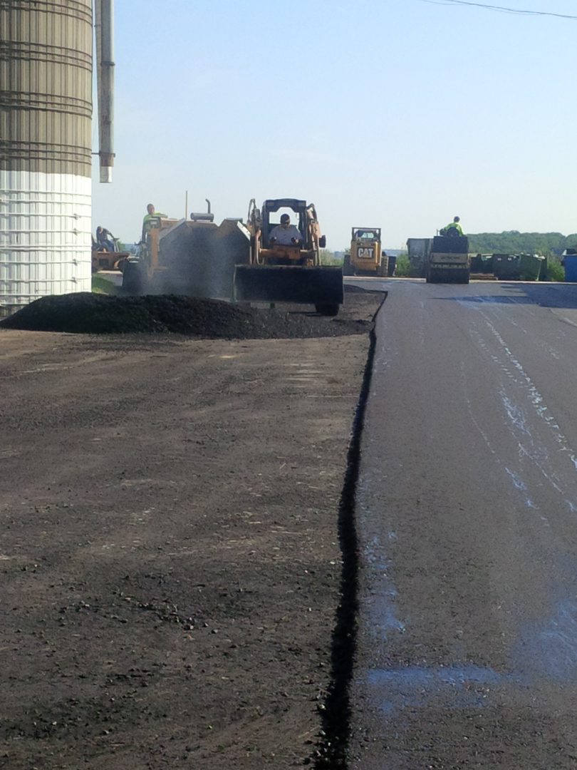 A road with asphalt being laid on it