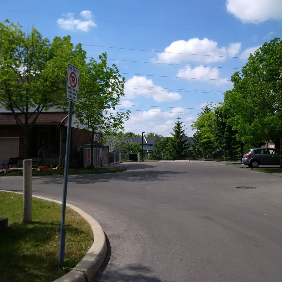 A street with cars parked on the side of it.