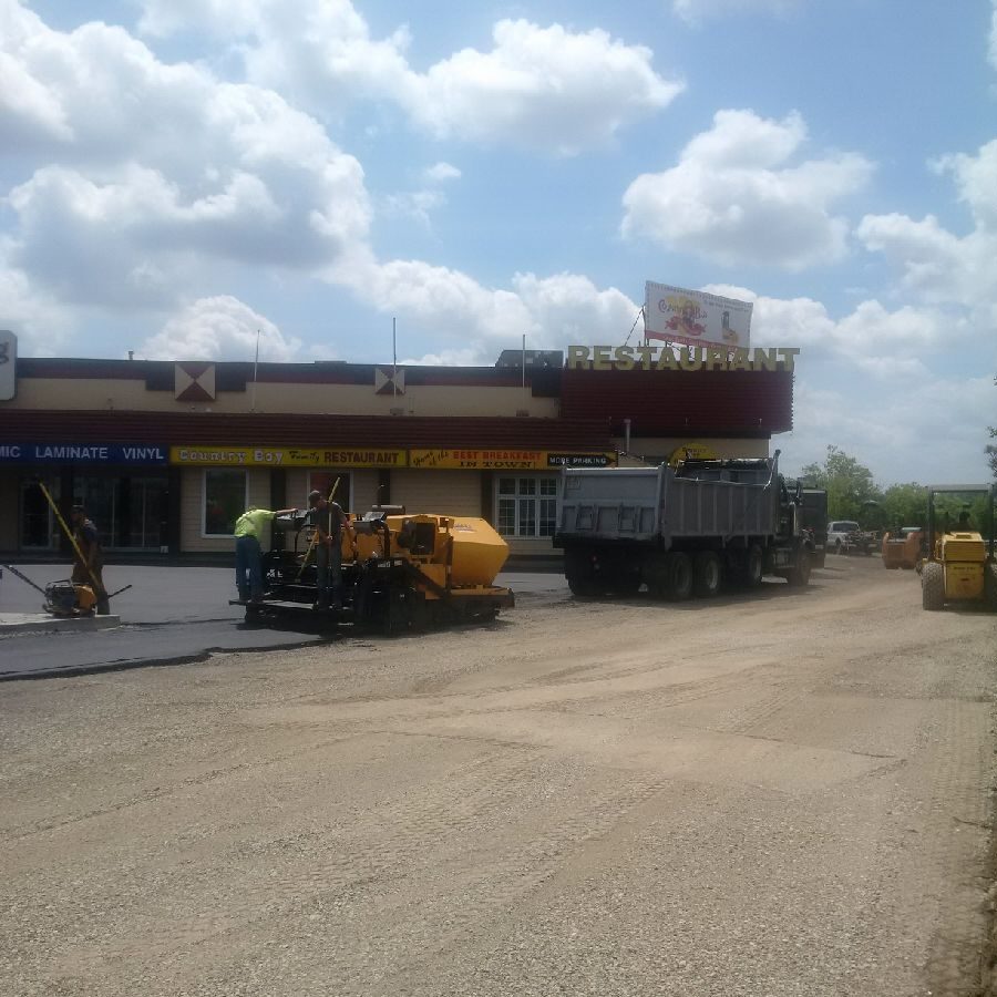 A cement truck parked on the side of a road.