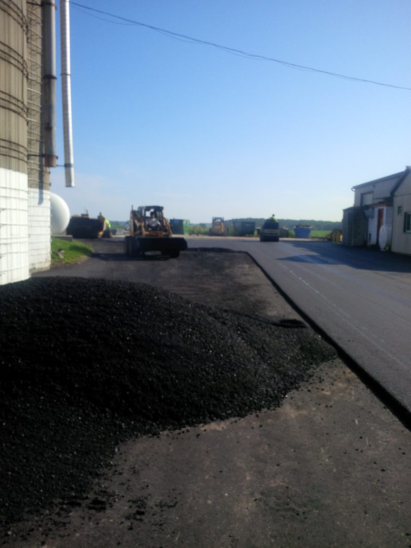 A road with asphalt being laid on it